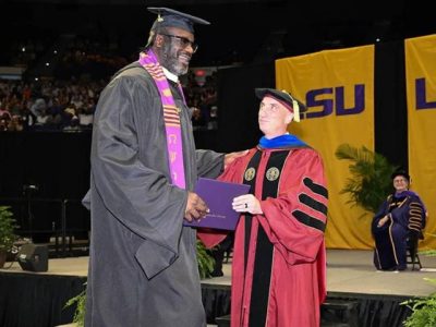 Legenda NBA Shaquille O'Neal tersenyum mengenakan toga saat wisuda S2 di Louisiana State University